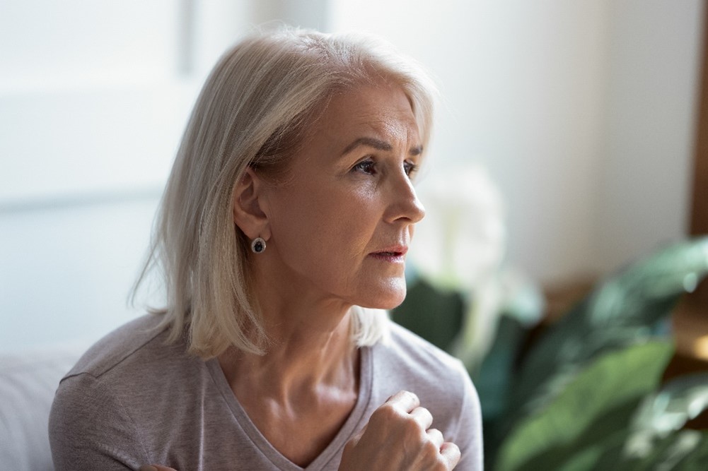 Lady with white hair looking off into the distance