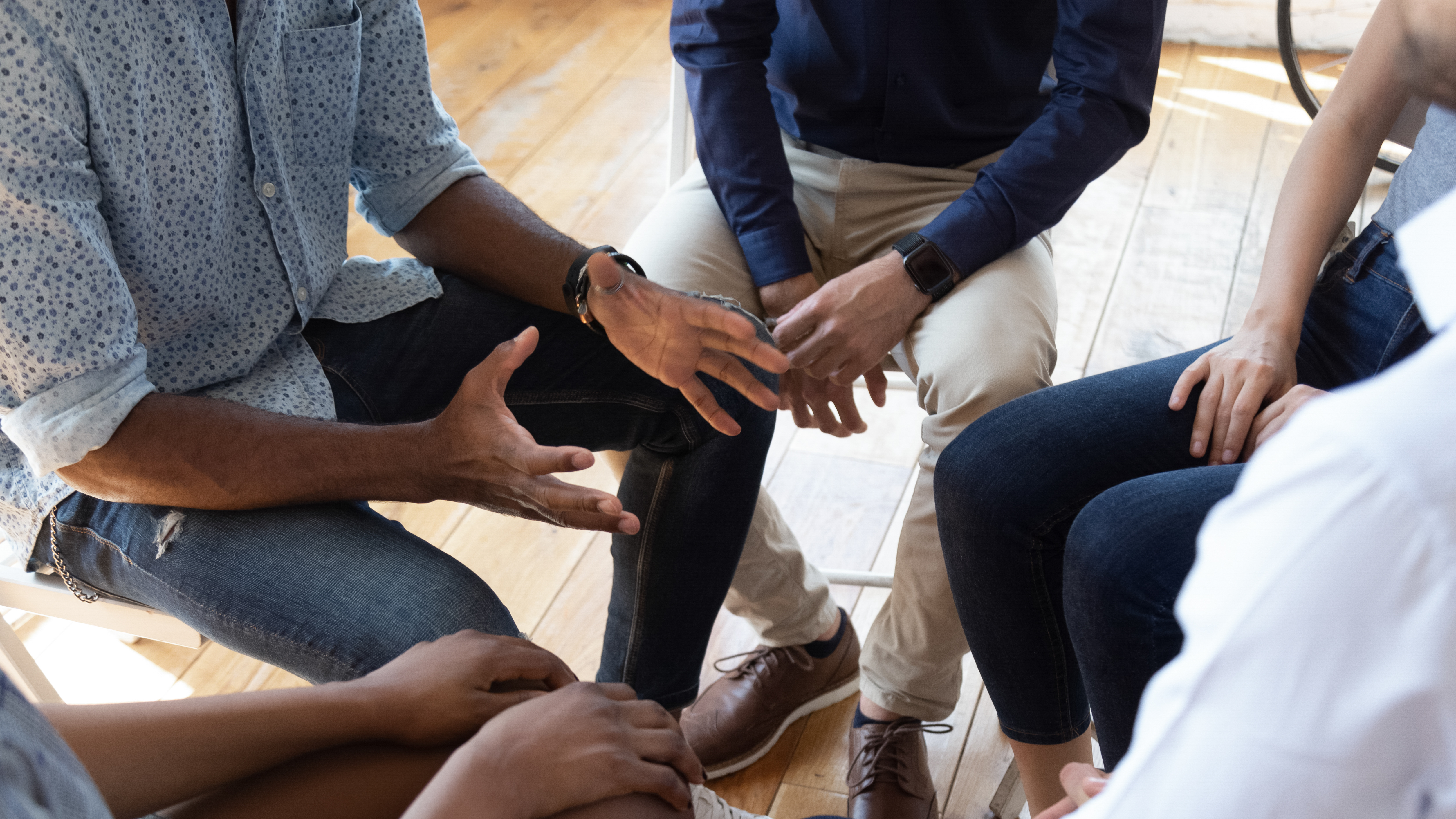 A group of people sat around in a circle having a discussion