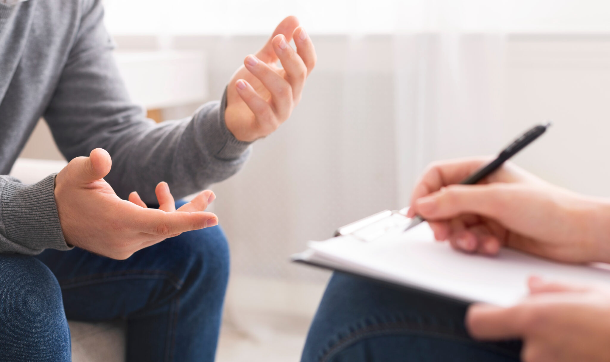 Two people having a discussion whilst one of them takes notes